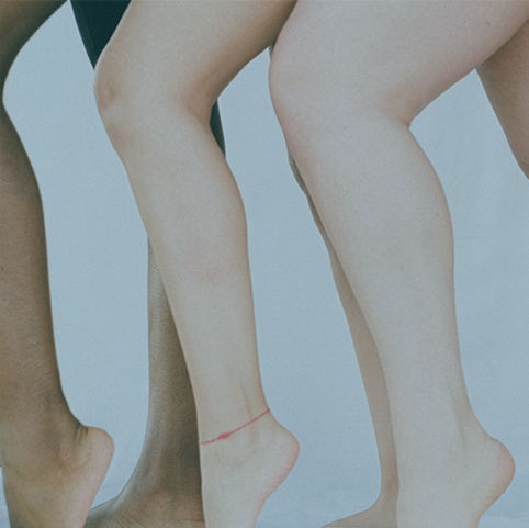 people’s legs in a group photo